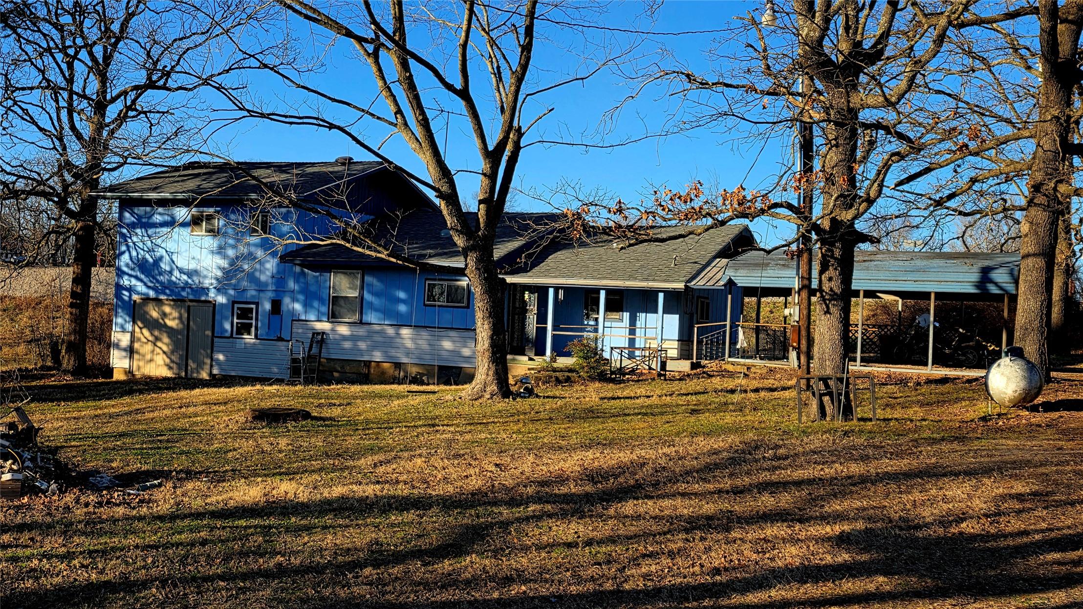 Image 3: Back of the multi-level home featuring new roof, s