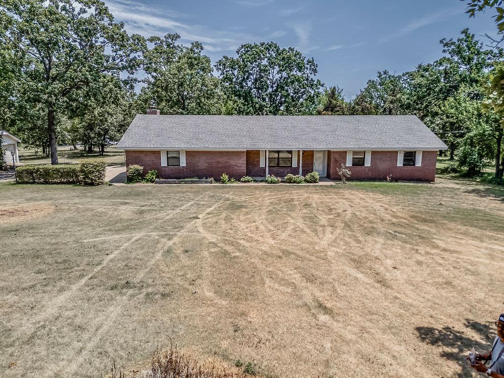 Image 1: Brick ranch-style residence featuring a gray shing