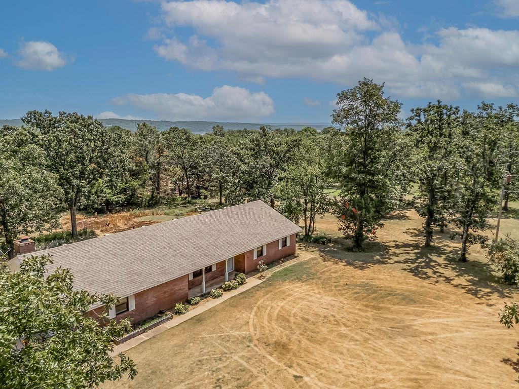 Image 3: Single-story brick exterior with a shingle roof an