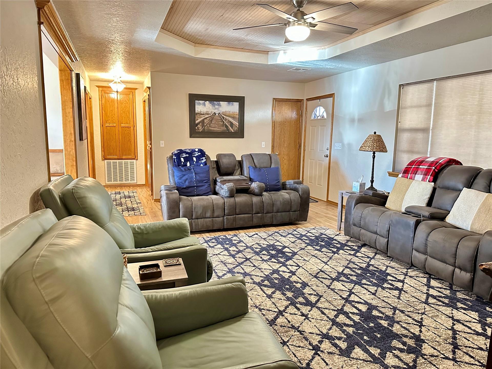 Image 4: Expansive living area featuring wood-finish floori