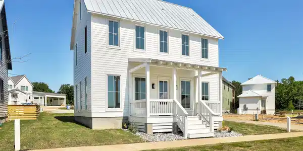Image 3: White clapboard siding with a metal roof