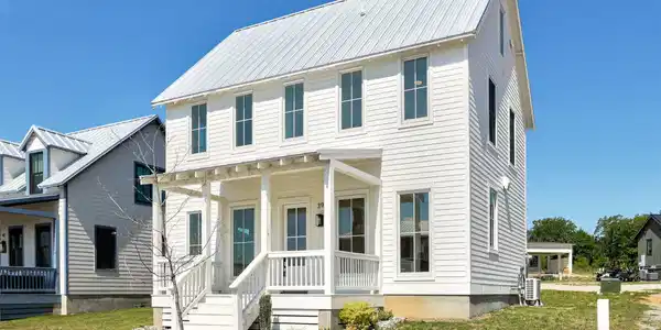 Image 4: White two-story residence featuring horizontal sid