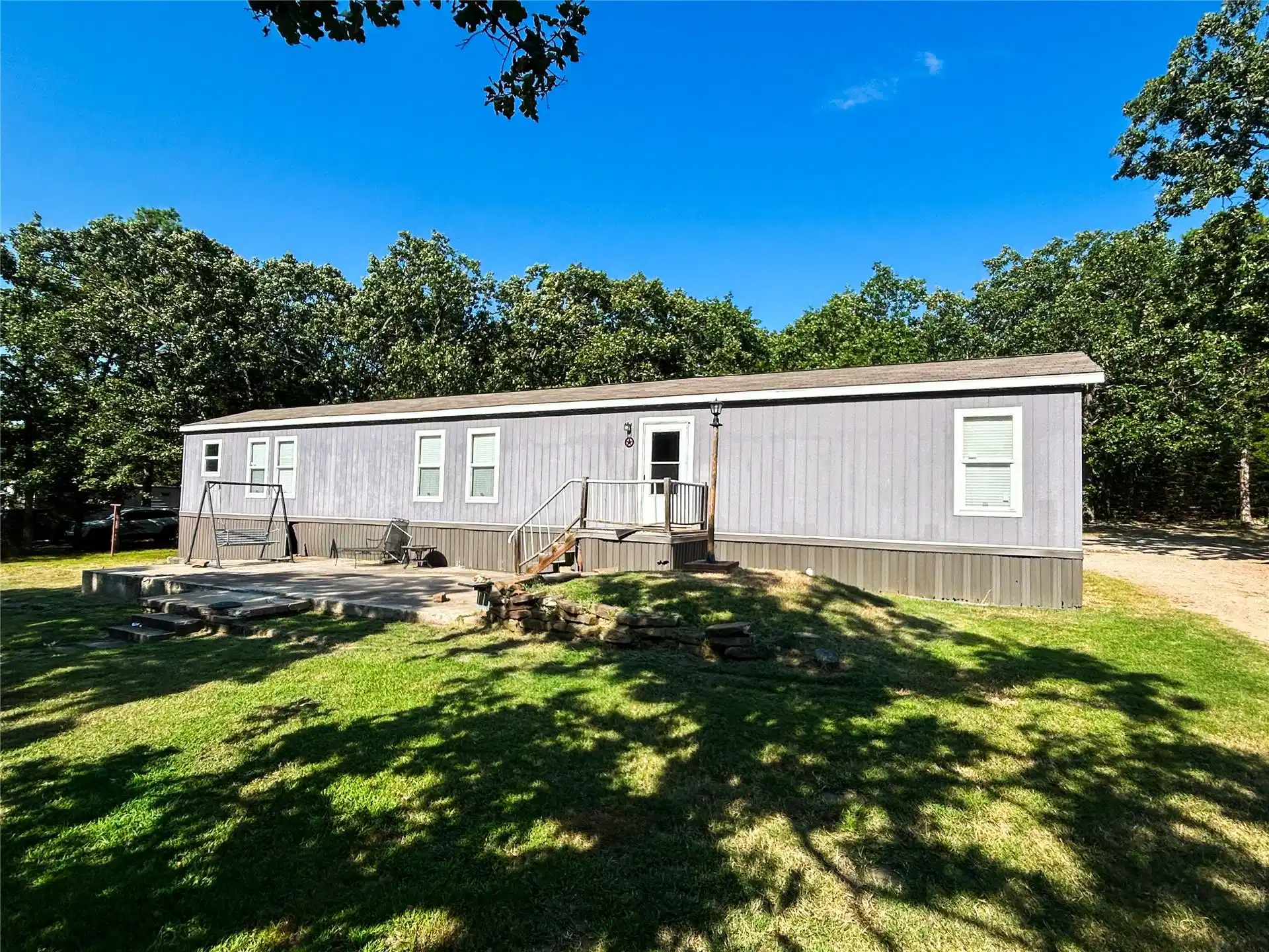 Image 1: Single-story residence featuring light blue siding