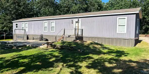 Image 4: Gray siding exterior with white window trim