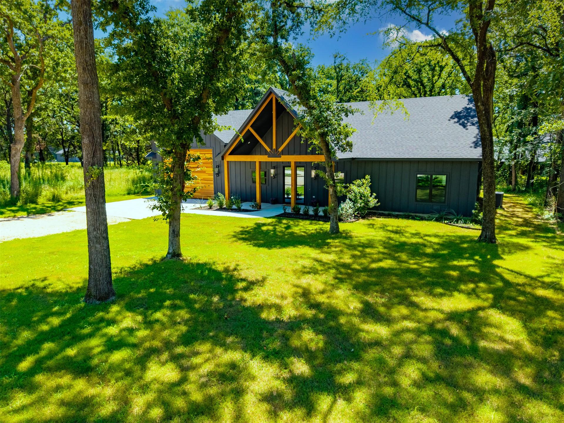 Image 2: Modern farmhouse exterior featuring dark vertical