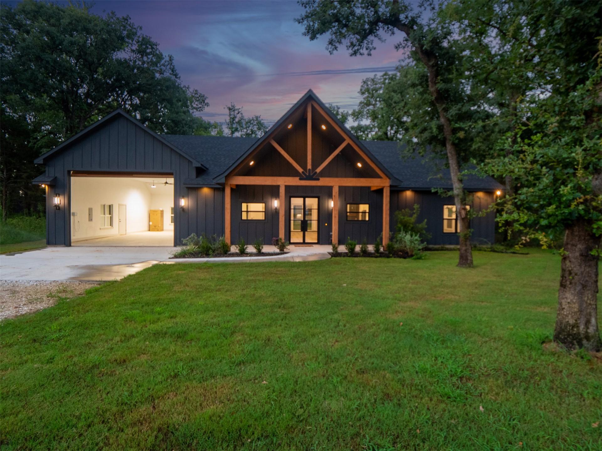 Image 3: Modern farmhouse exterior featuring dark vertical