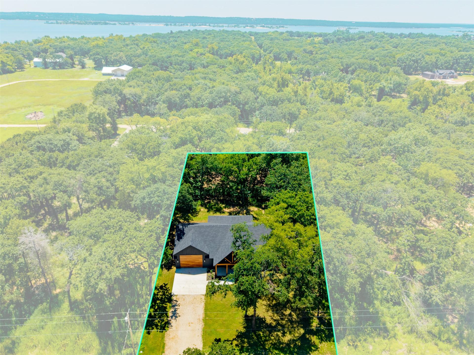 Image 4: Modern ranch-style home featuring a dark shingle r