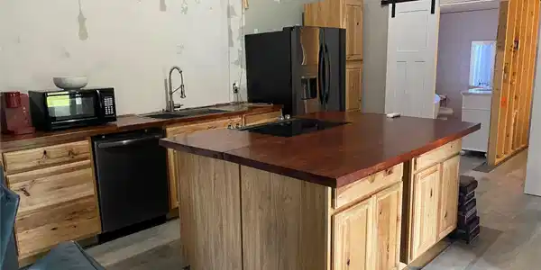 Image 4: Kitchen featuring a large central island with a wo
