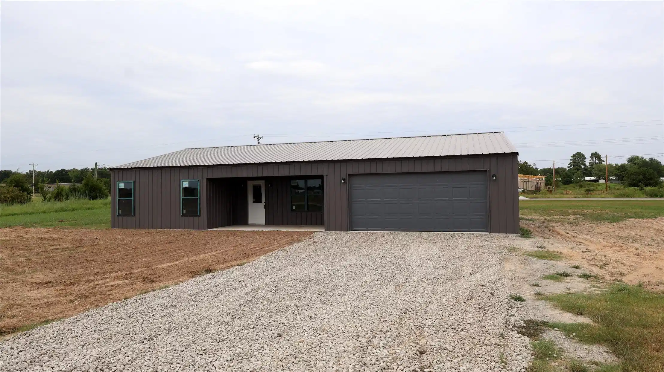 Image 1: Modern metal-sided structure featuring a gray meta