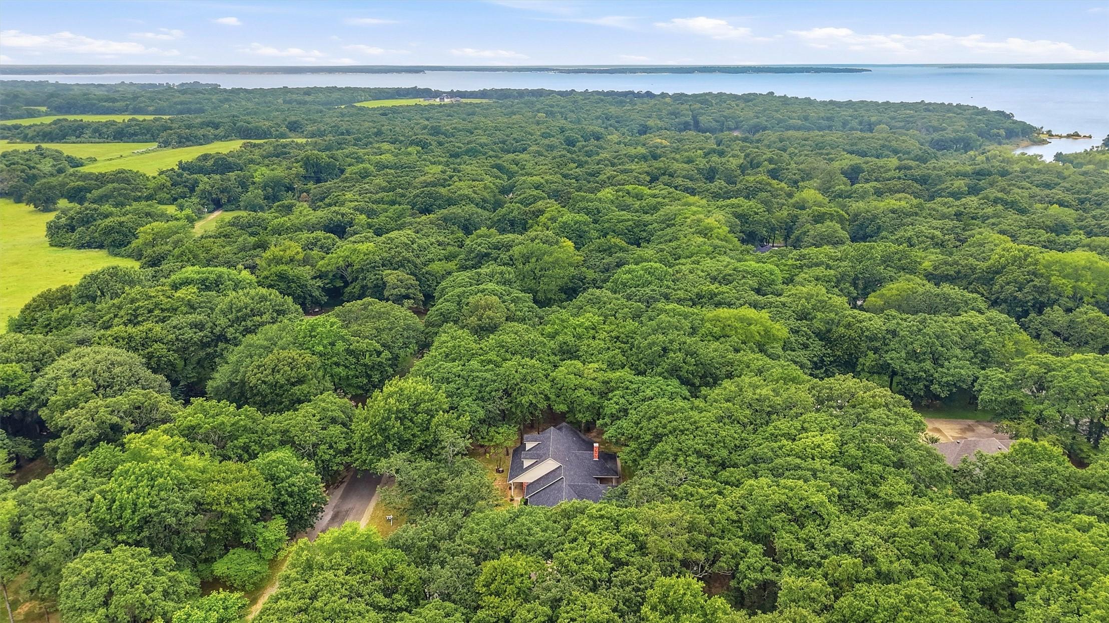 Image 2: Aerial property showcasing extensive surrounding t