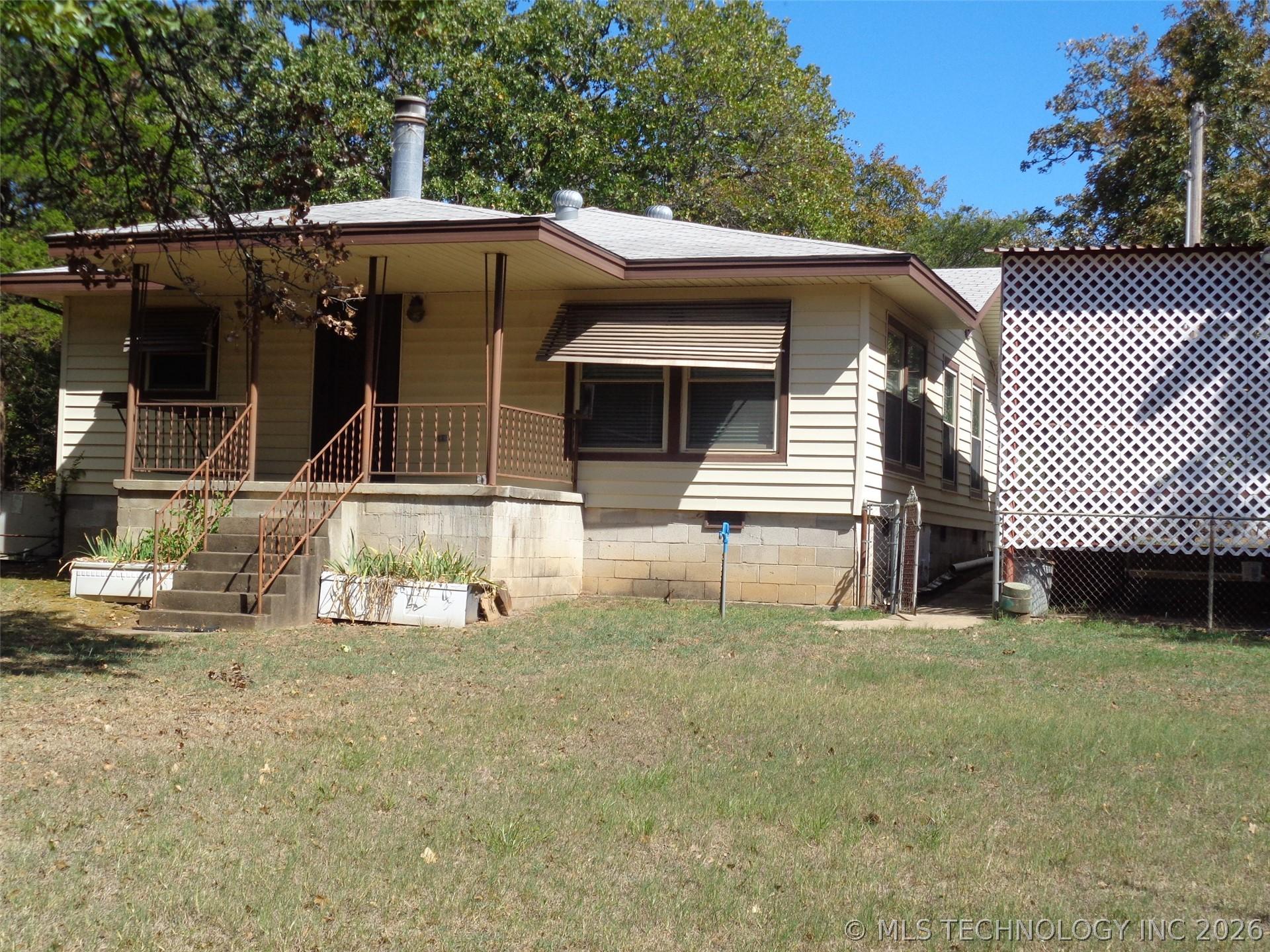 Image 3: Another View of Front of Property; Tall carport al