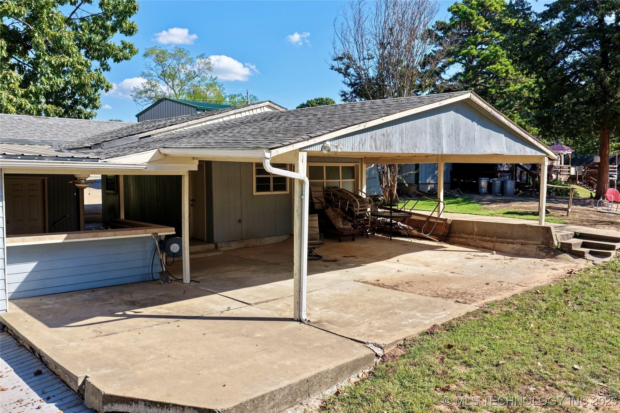 Image 3: Outdoor Kitchen on Left of Photo and Large Covered