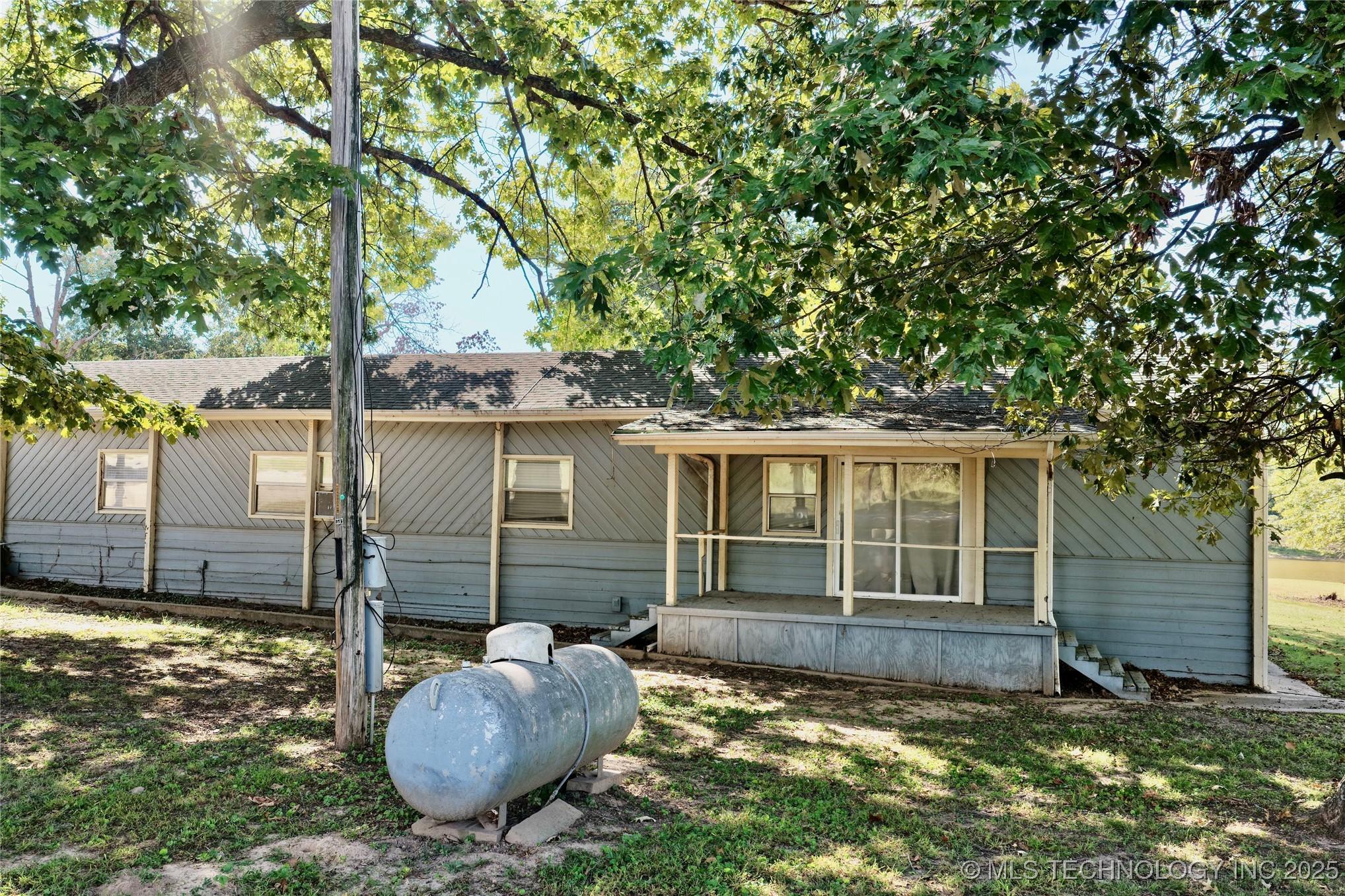 Image 4: Opposite end of home has covered porch.