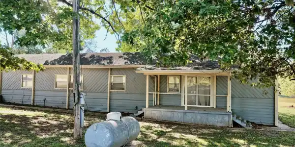 Image 4: Opposite end of home has covered porch.