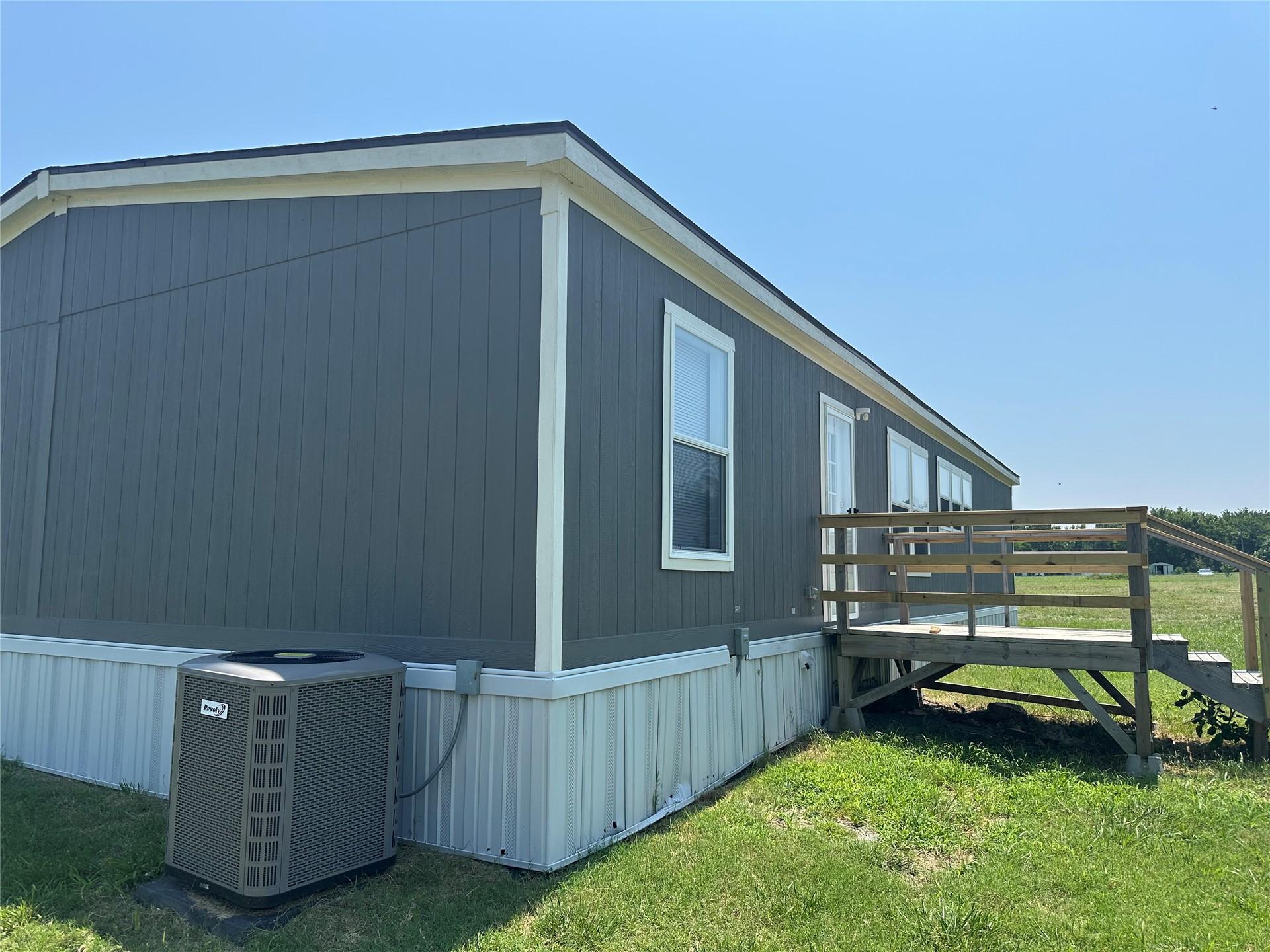 Image 2: Exterior featuring vertical panel siding, white tr
