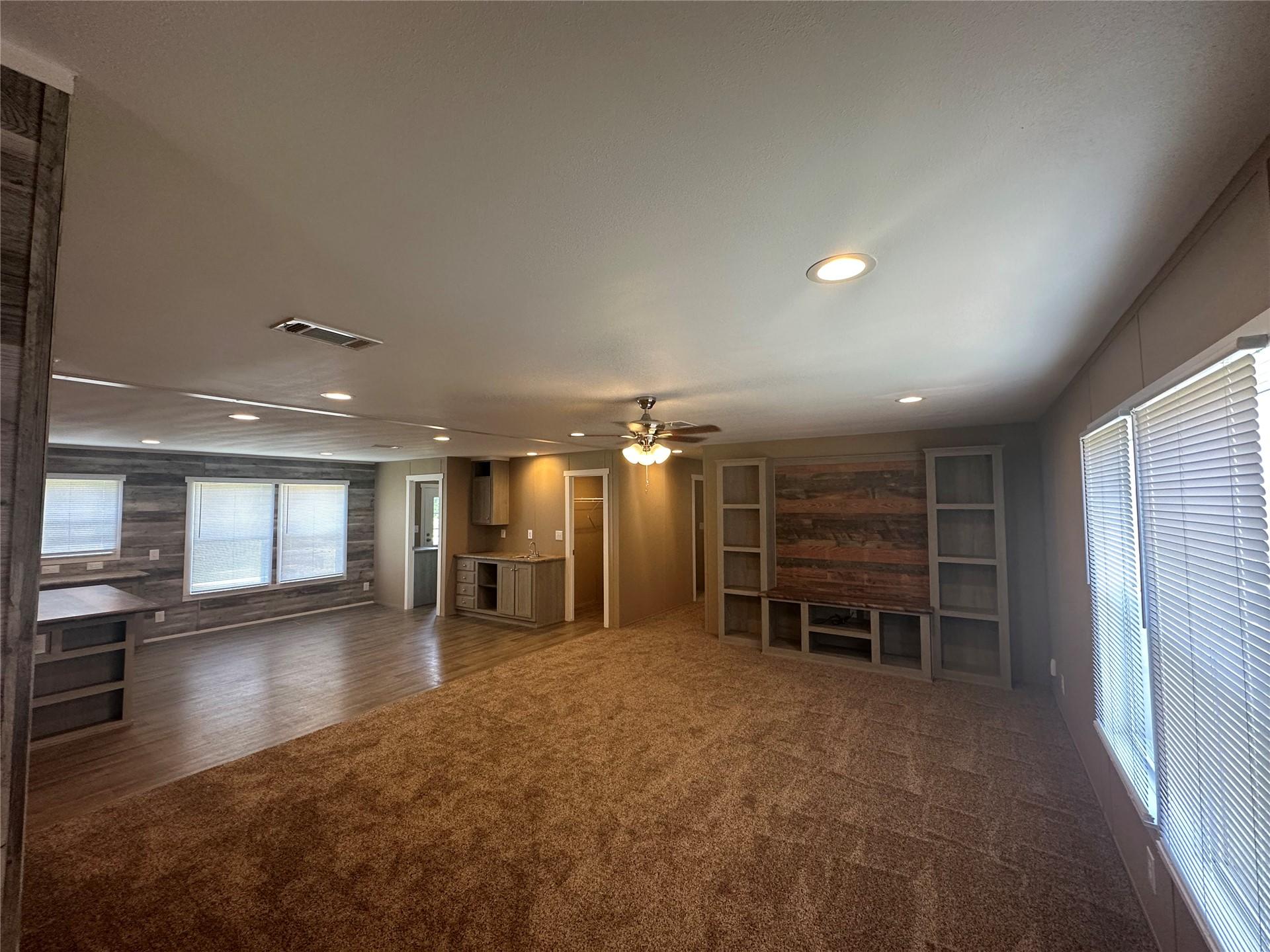 Image 4: Open concept living area with recessed lighting, c