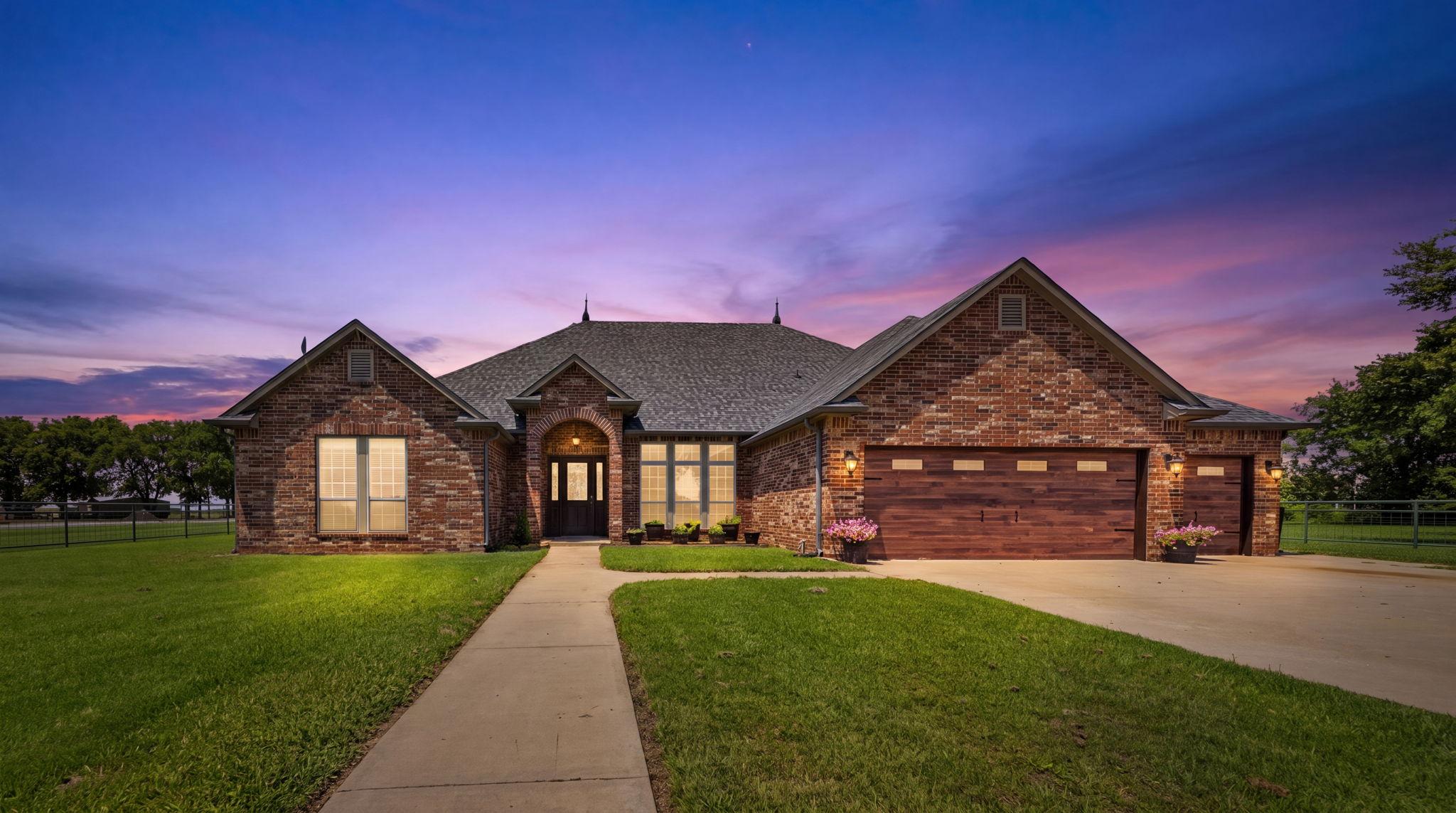 Image 1: Brick residence featuring a gabled roofline, arche