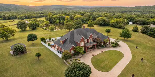 Image 3: Expansive property featuring a brick exterior resi