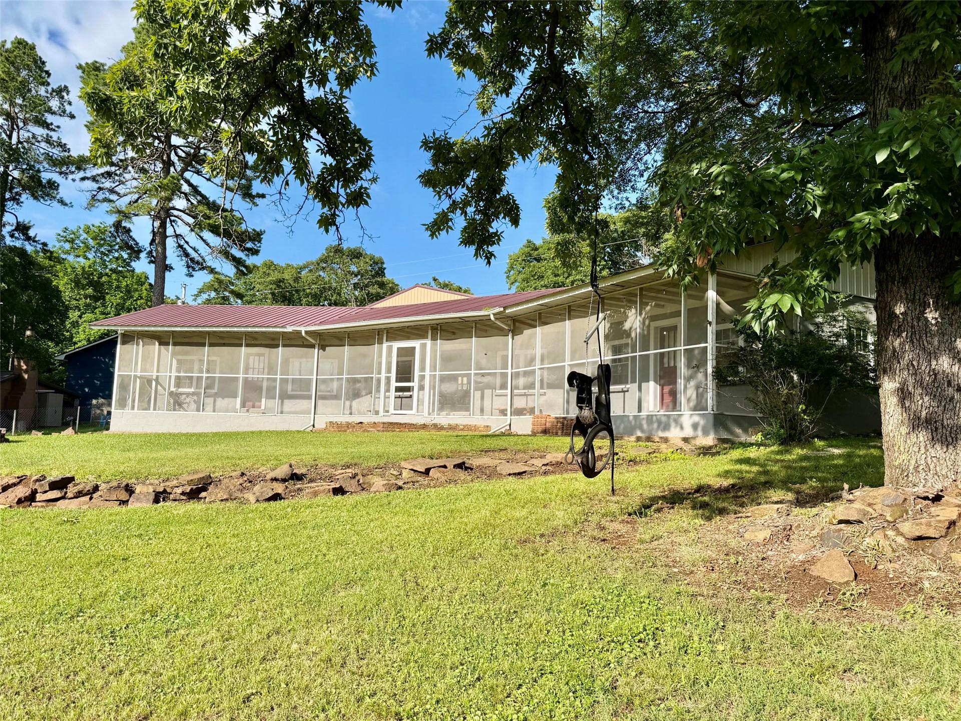 Image 1: Expansive screened-in porch with multiple entry po
