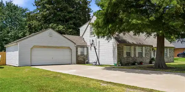 Image 2: Exterior featuring a two-car attached garage, a pa