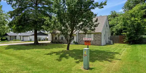 Image 4: Brick and siding exterior residence with a pitched