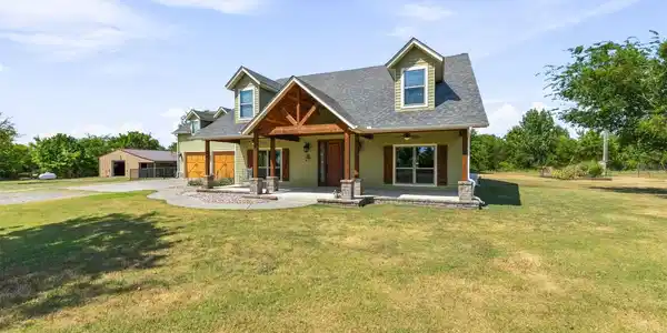 Image 2: Charming farmhouse-style residence featuring a pea