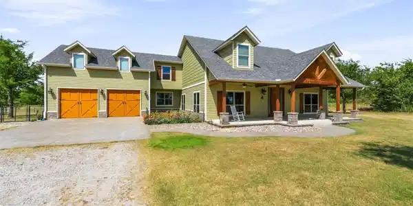 Image 3: Expansive two-story residence featuring light gree