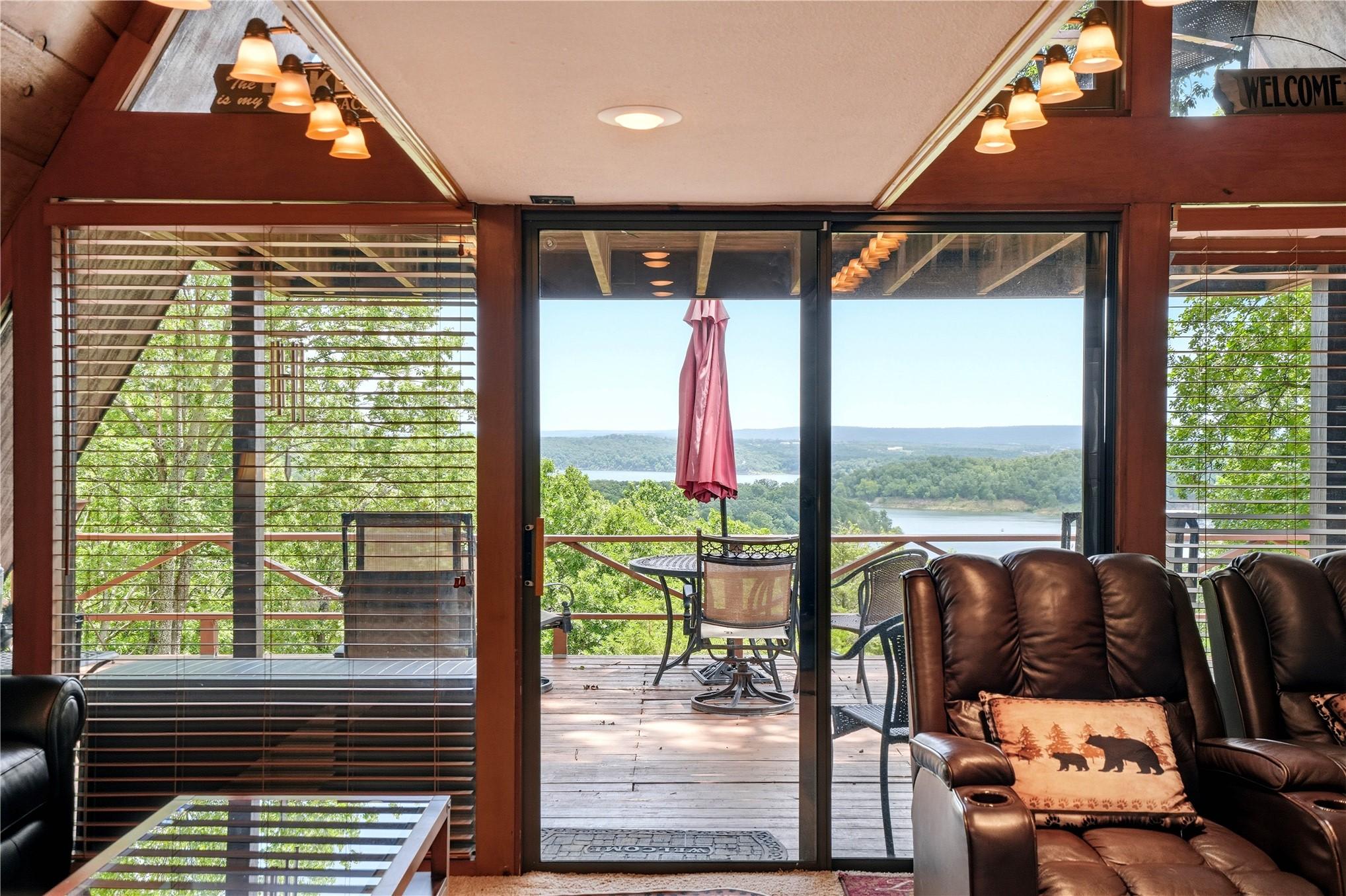 Image 3: Sliding glass door opening to a private wooden dec