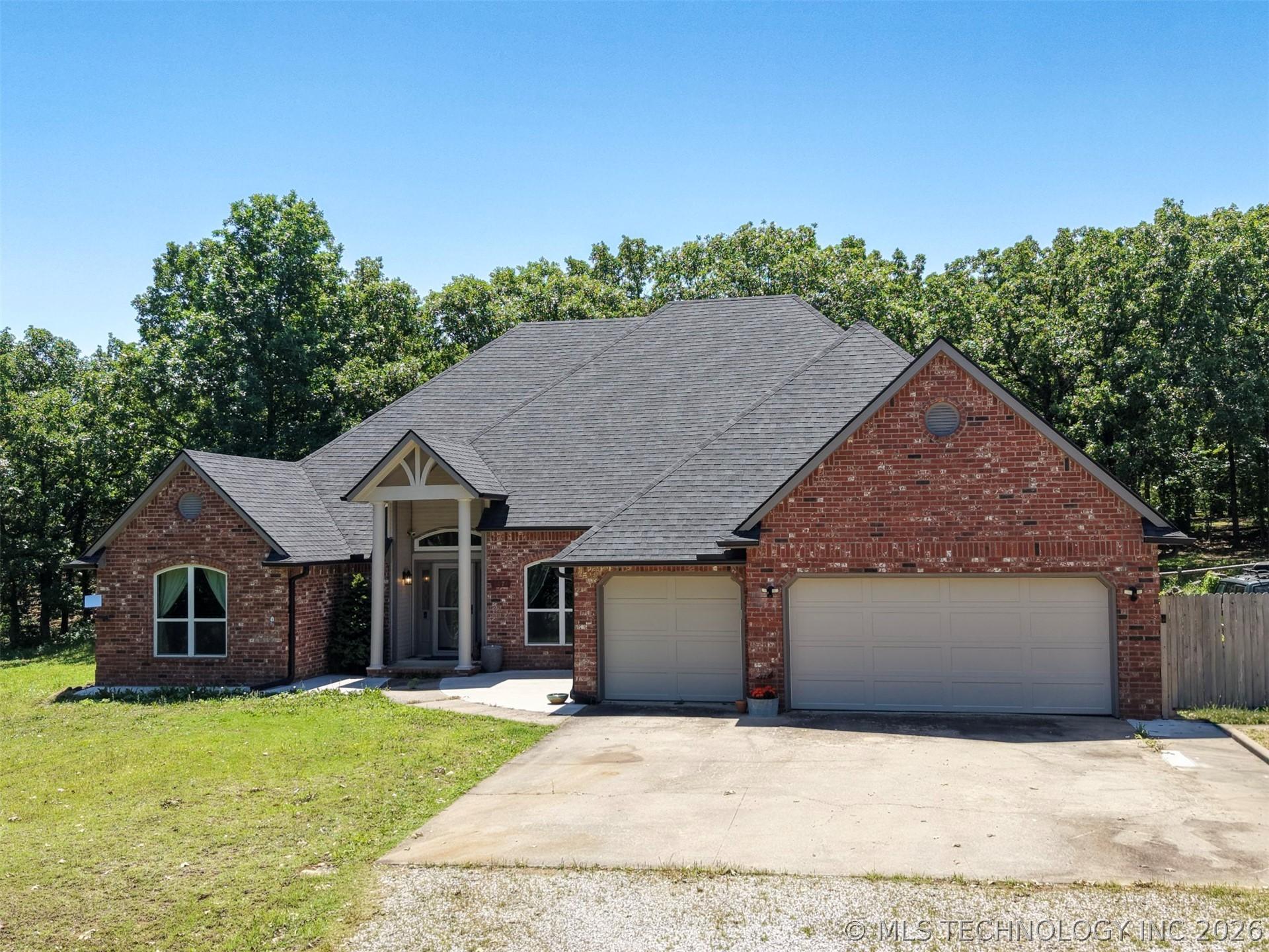 Image 3: Brick exterior with a prominent covered entry feat