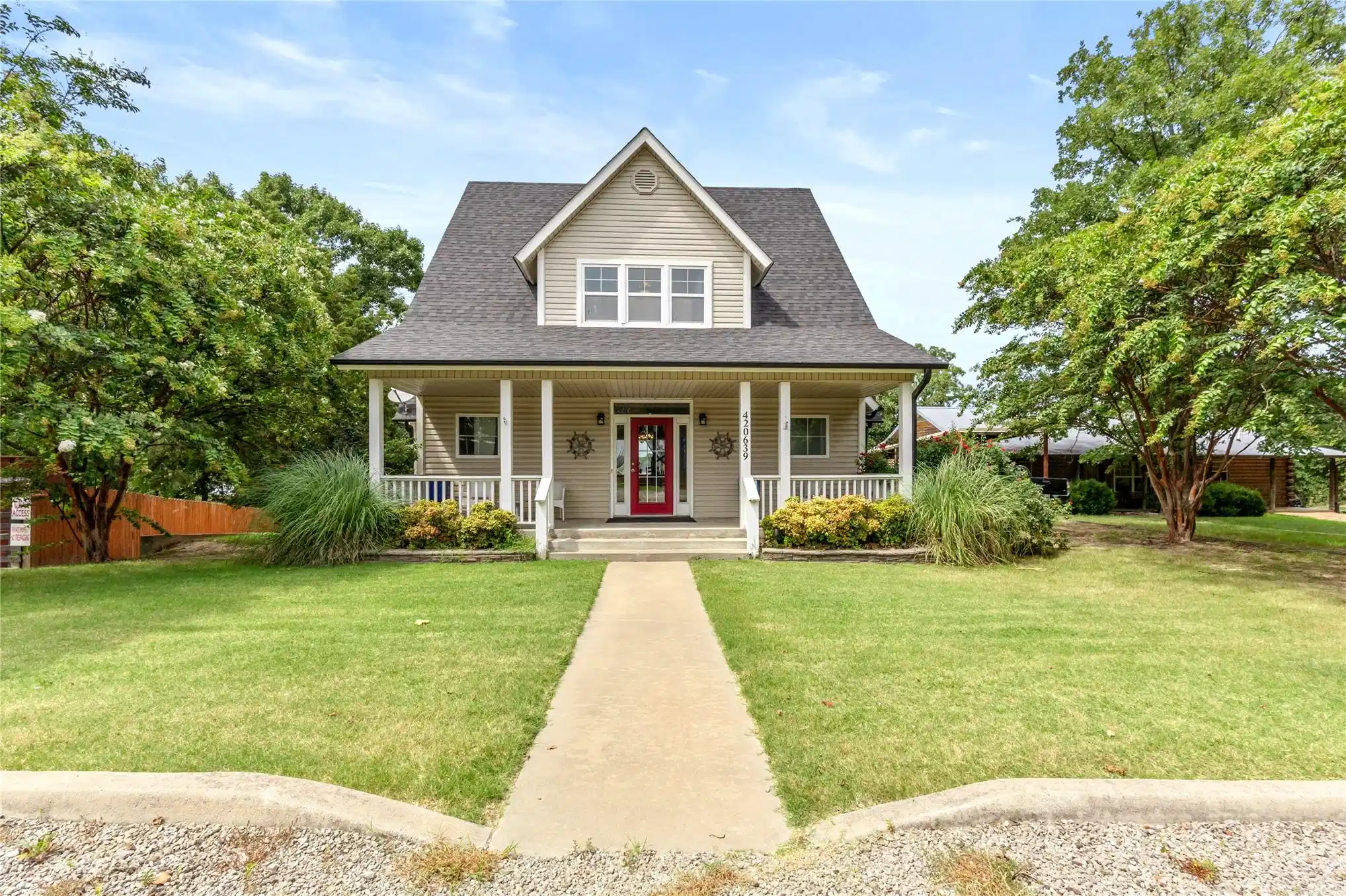 Image 1: Gable-roof property featuring a welcoming covered