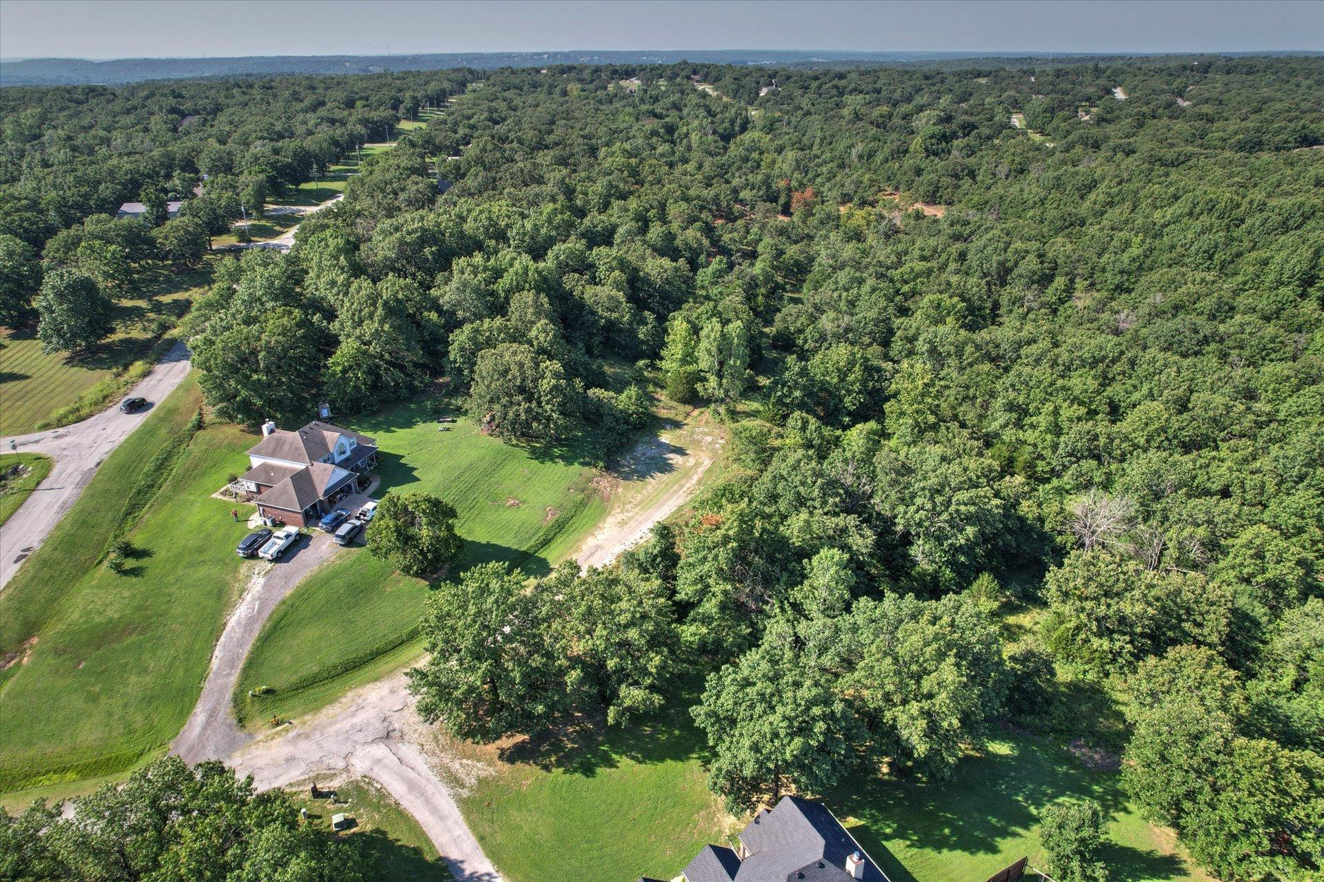 Image 3: Spacious property surrounded by extensive tree cov