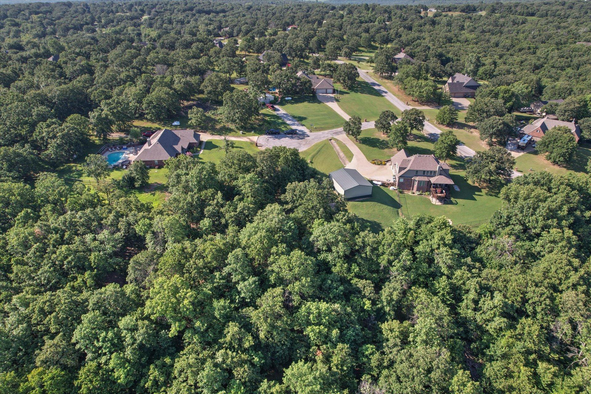 Image 1: Expansive wooded acreage featuring a detached meta