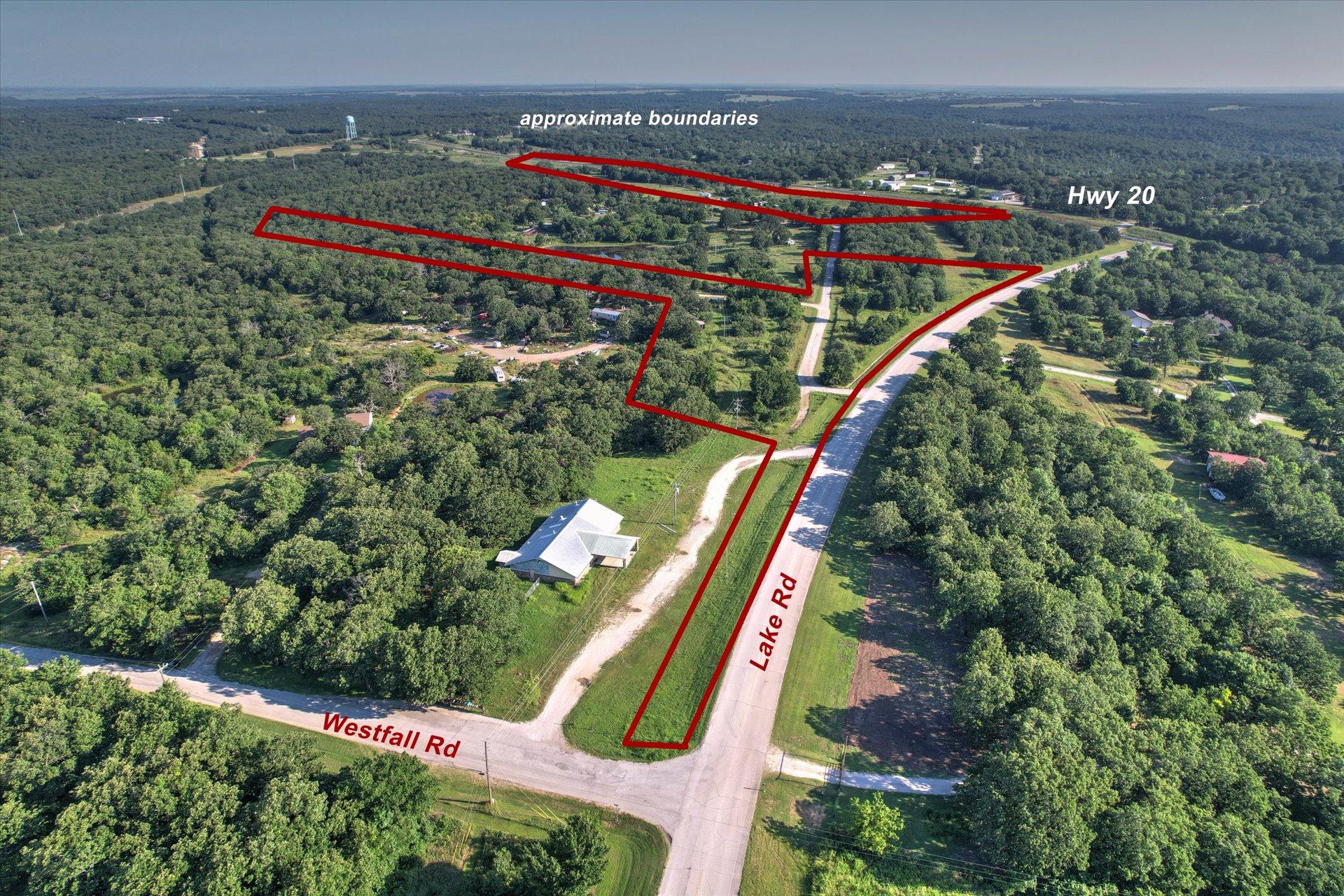 Image 1: Aerial overview showcasing extensive wooded acreag