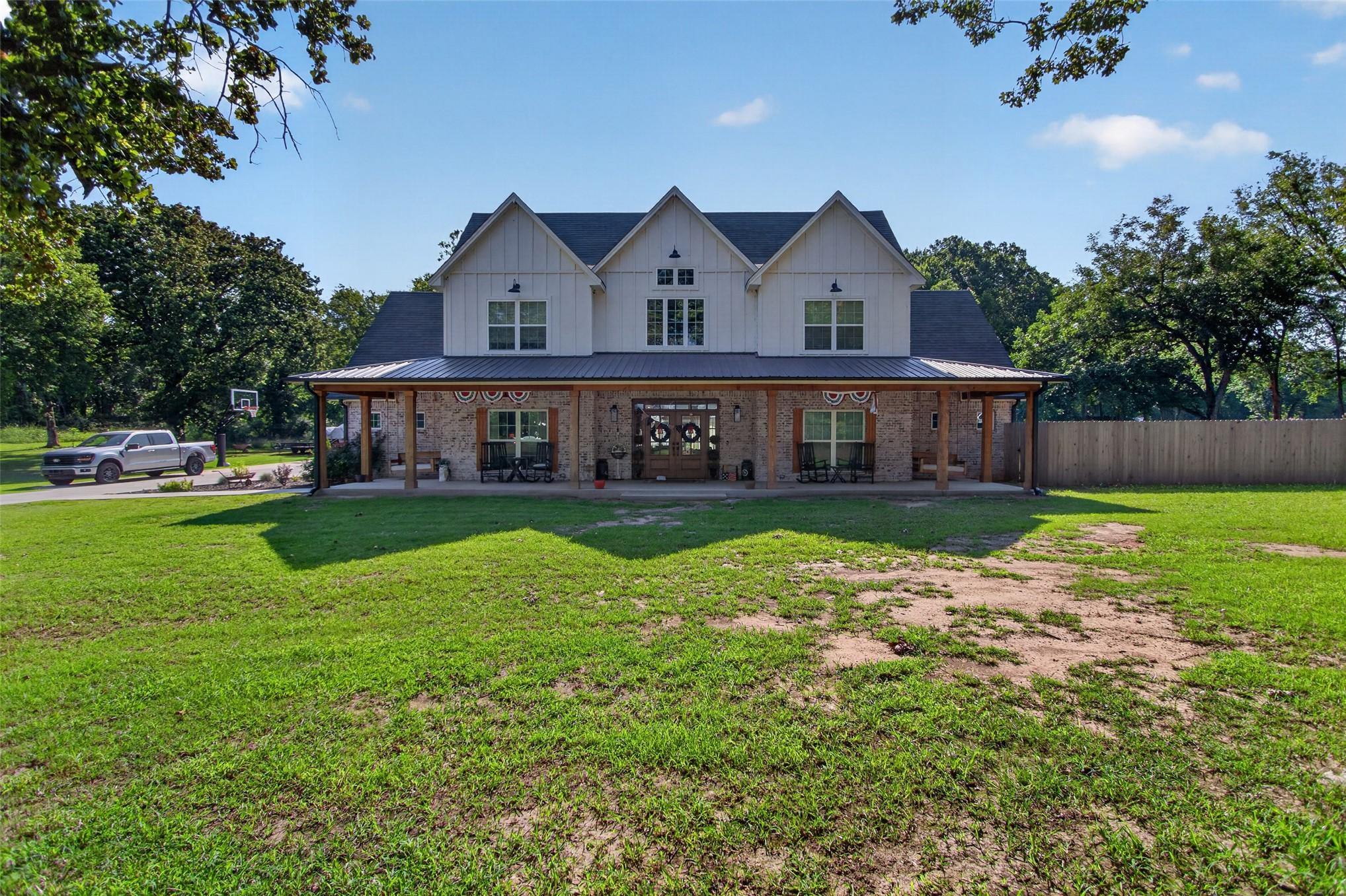 Image 3: Two-story residence featuring a covered front porc