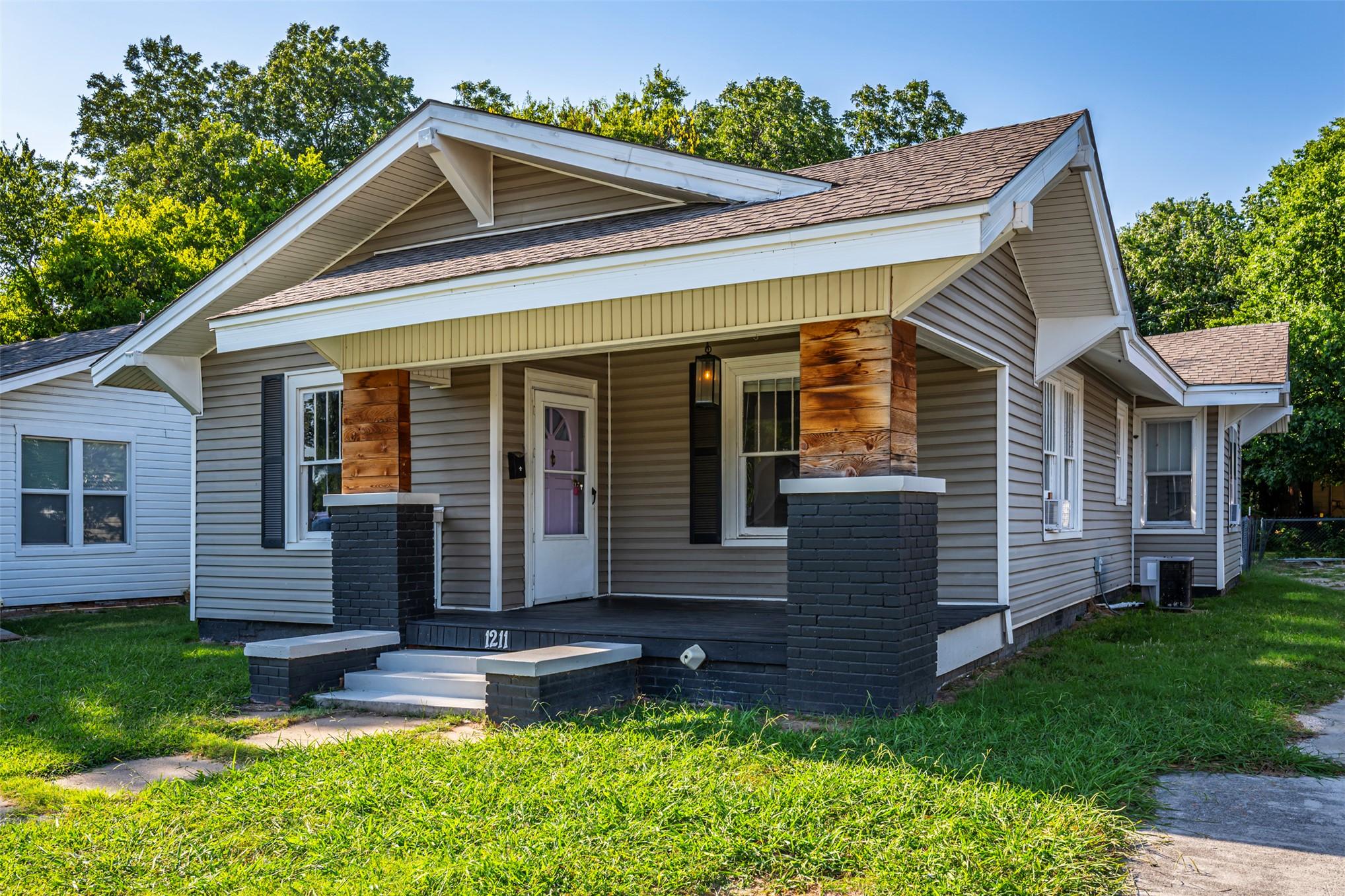 Image 2: Exterior featuring light gray horizontal siding, a