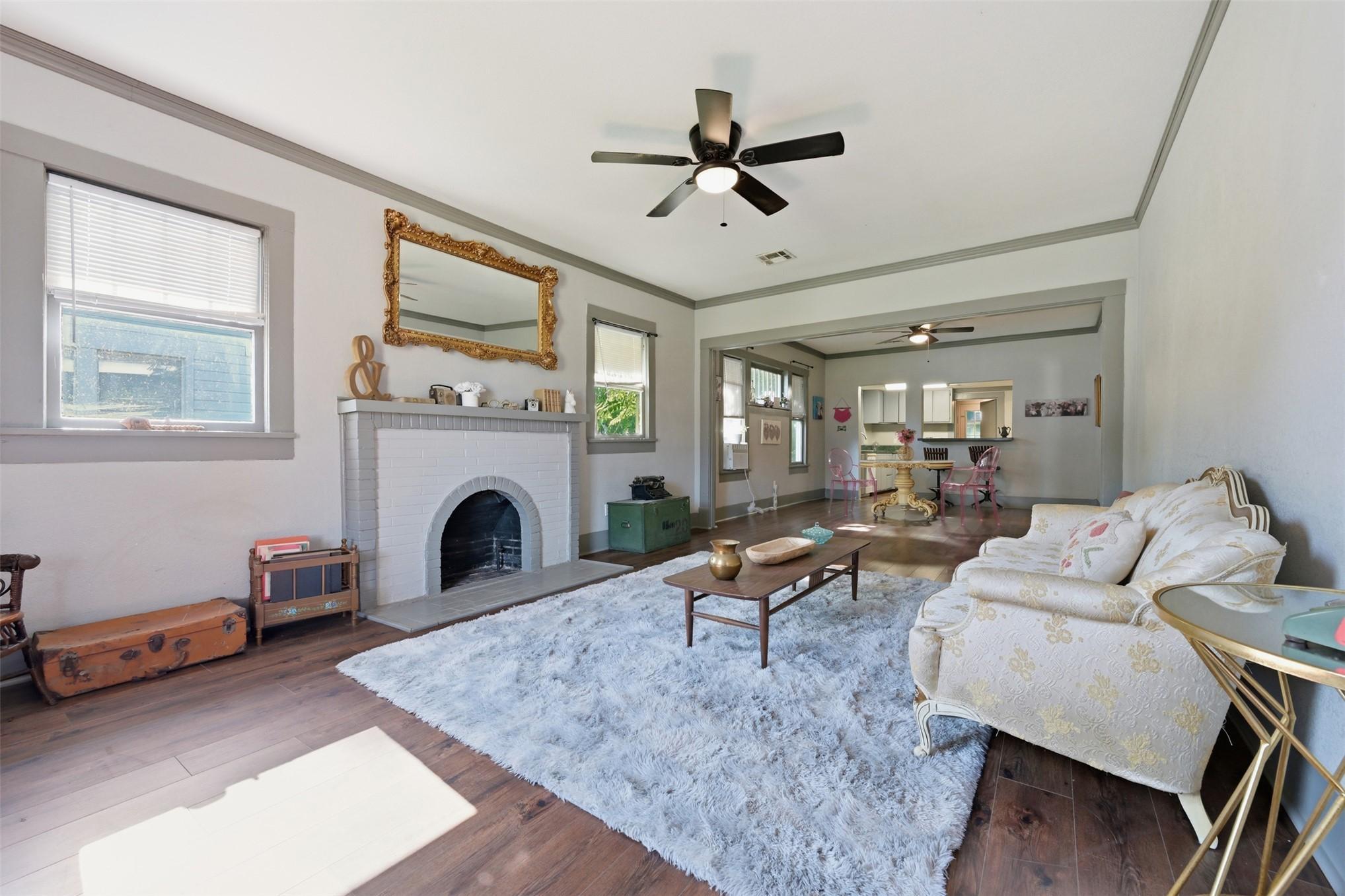Image 4: Living area featuring wood-finish flooring, a whit