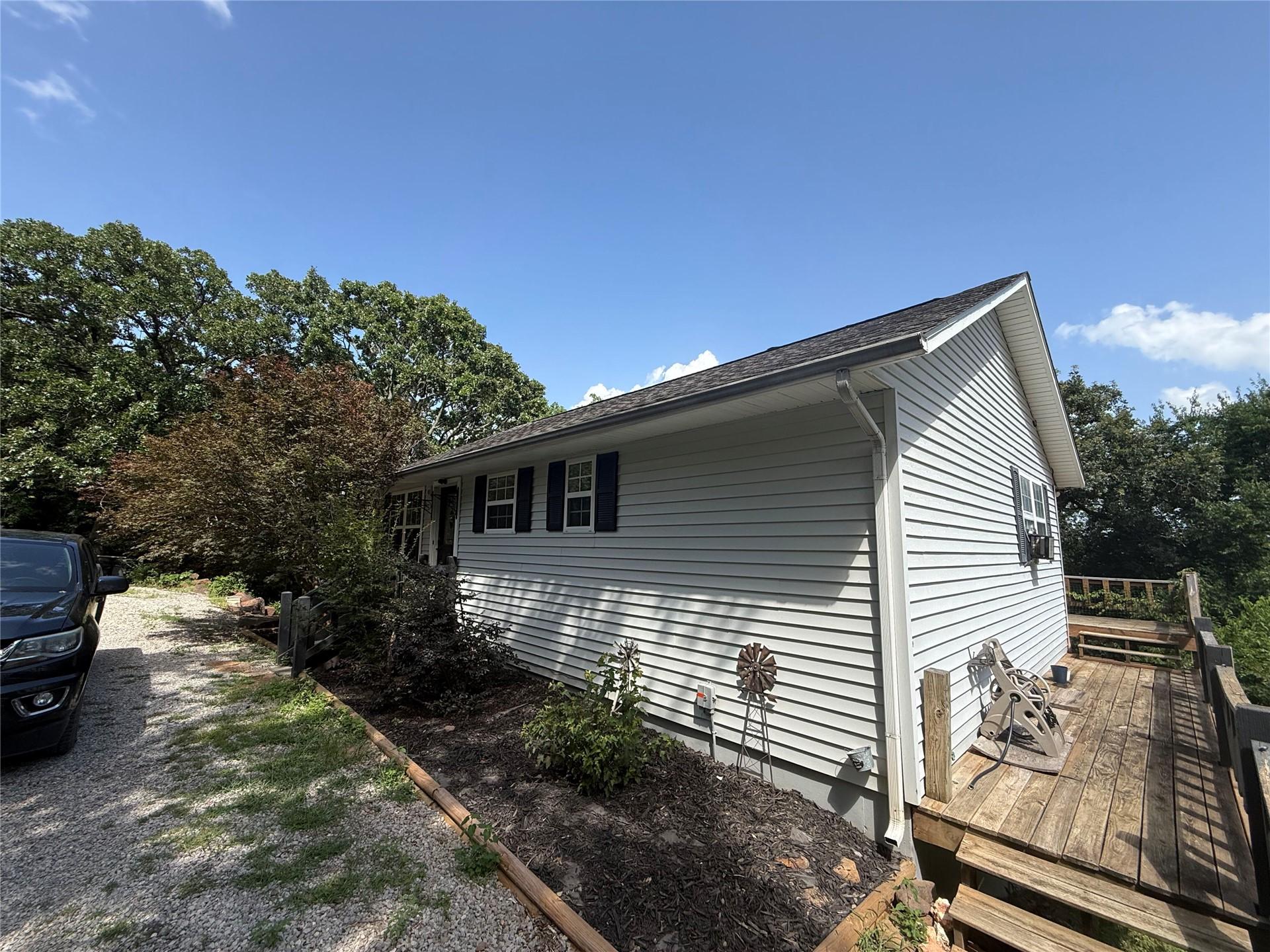 Image 2: Side elevation with light-colored siding and dark