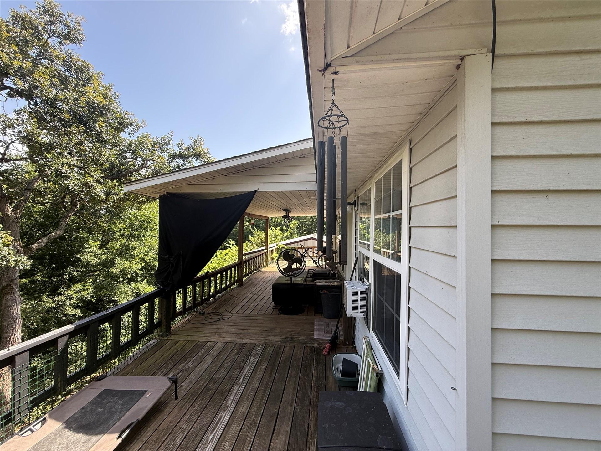 Image 3: Expansive wood deck with a partial overhead coveri