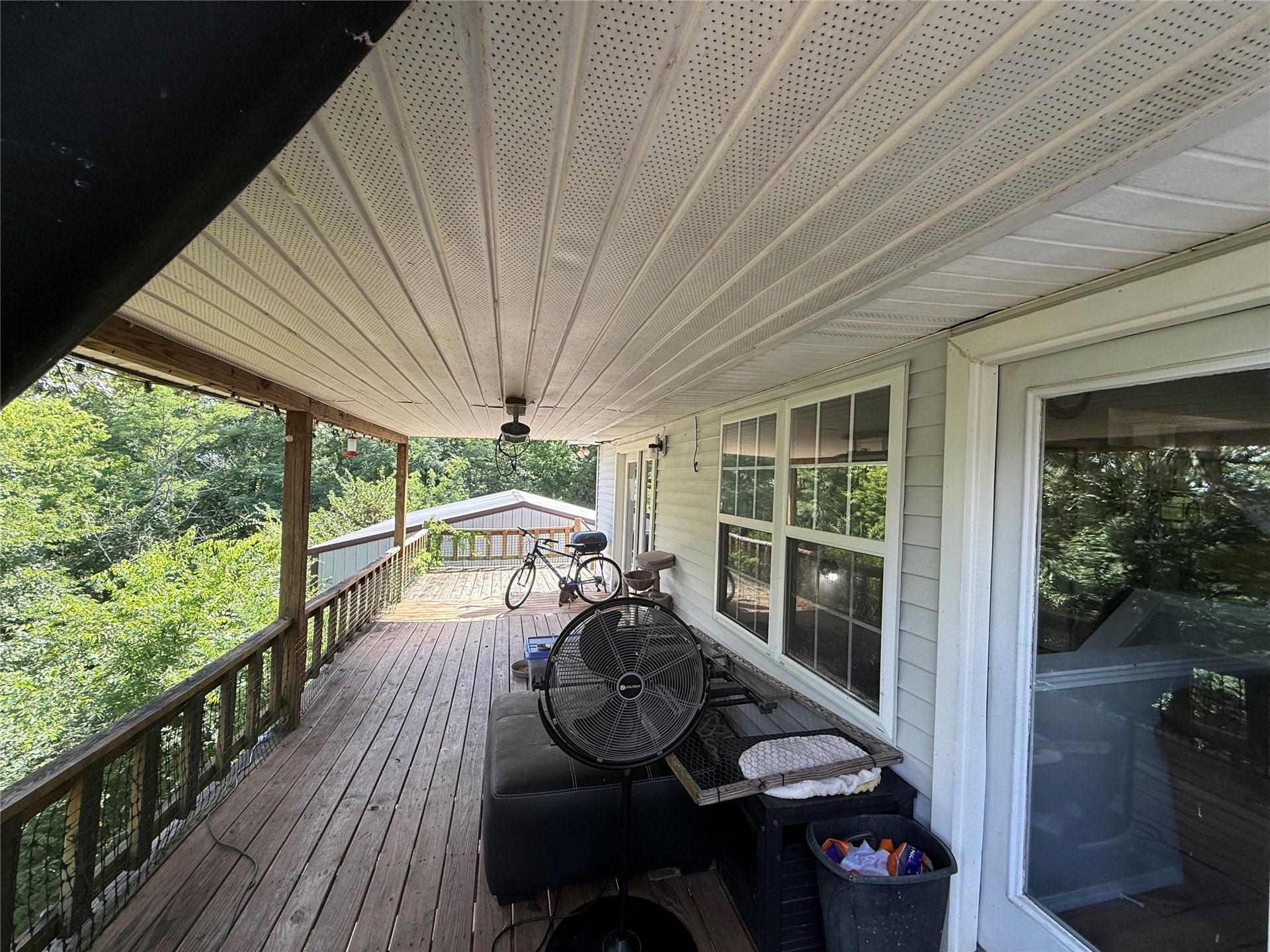 Image 4: Expansive covered wood deck featuring a ceiling fa