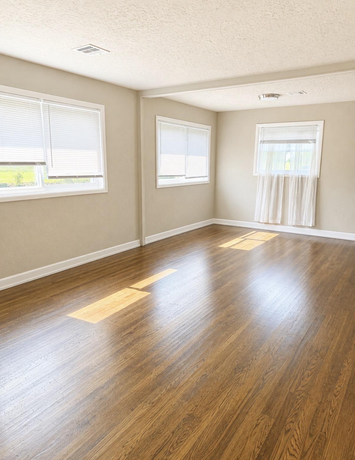 Image 2: Spacious room featuring wood-finish flooring, neut
