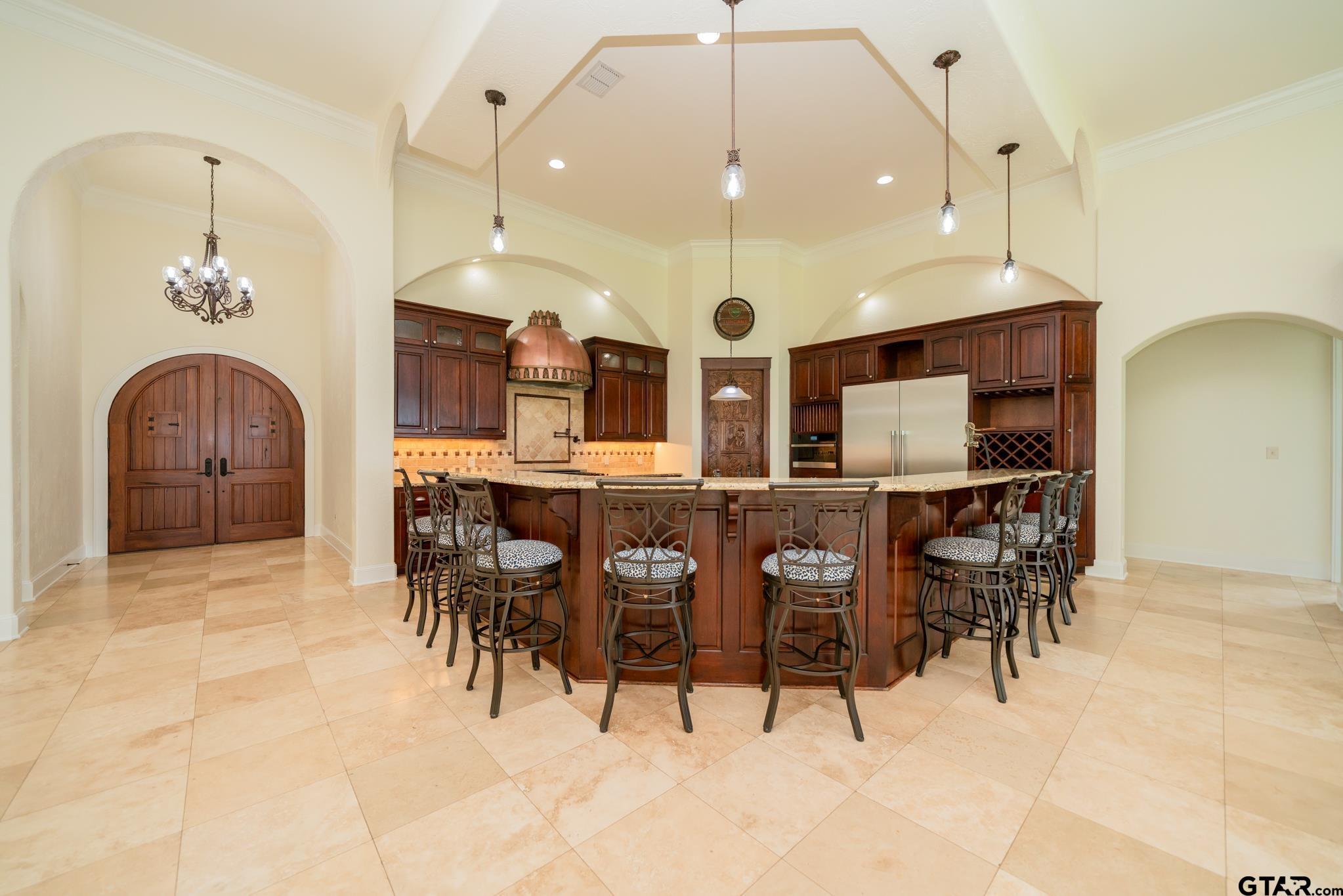 Image 3: Double Arched Doors made from Indian Walnut with "Speak Easy" opening panels., Double Arched Entry Doors Lead to Expansive Family