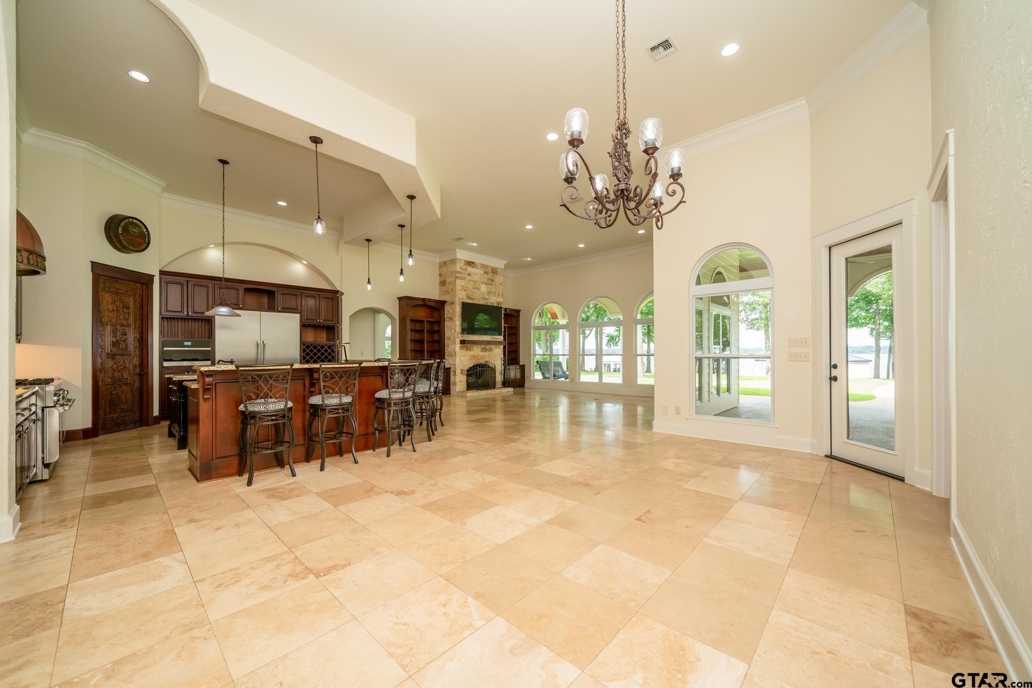 Image 4: 14' Ceiling & Large Arched Windows Bring the Outside In Giving the 35' x 33' Family Room Airy Feel, Airy Light Family Room