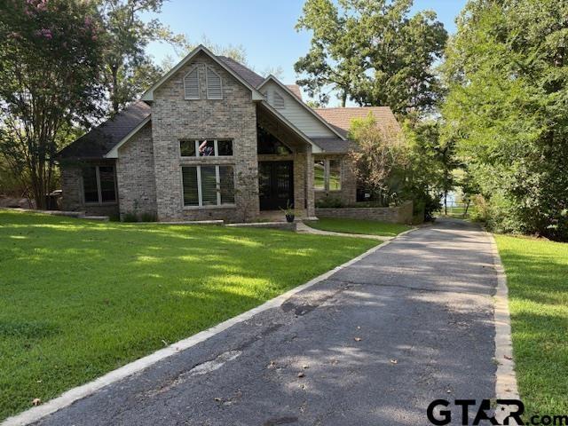 Image 1: IMPRESSIVE DRIVE-UP APPEAL WITH CONCRETE DRIVE, STONE PAVER WALKWAY LEADING TO WROUGHT IRON DOOR., FRONT ELEVATION