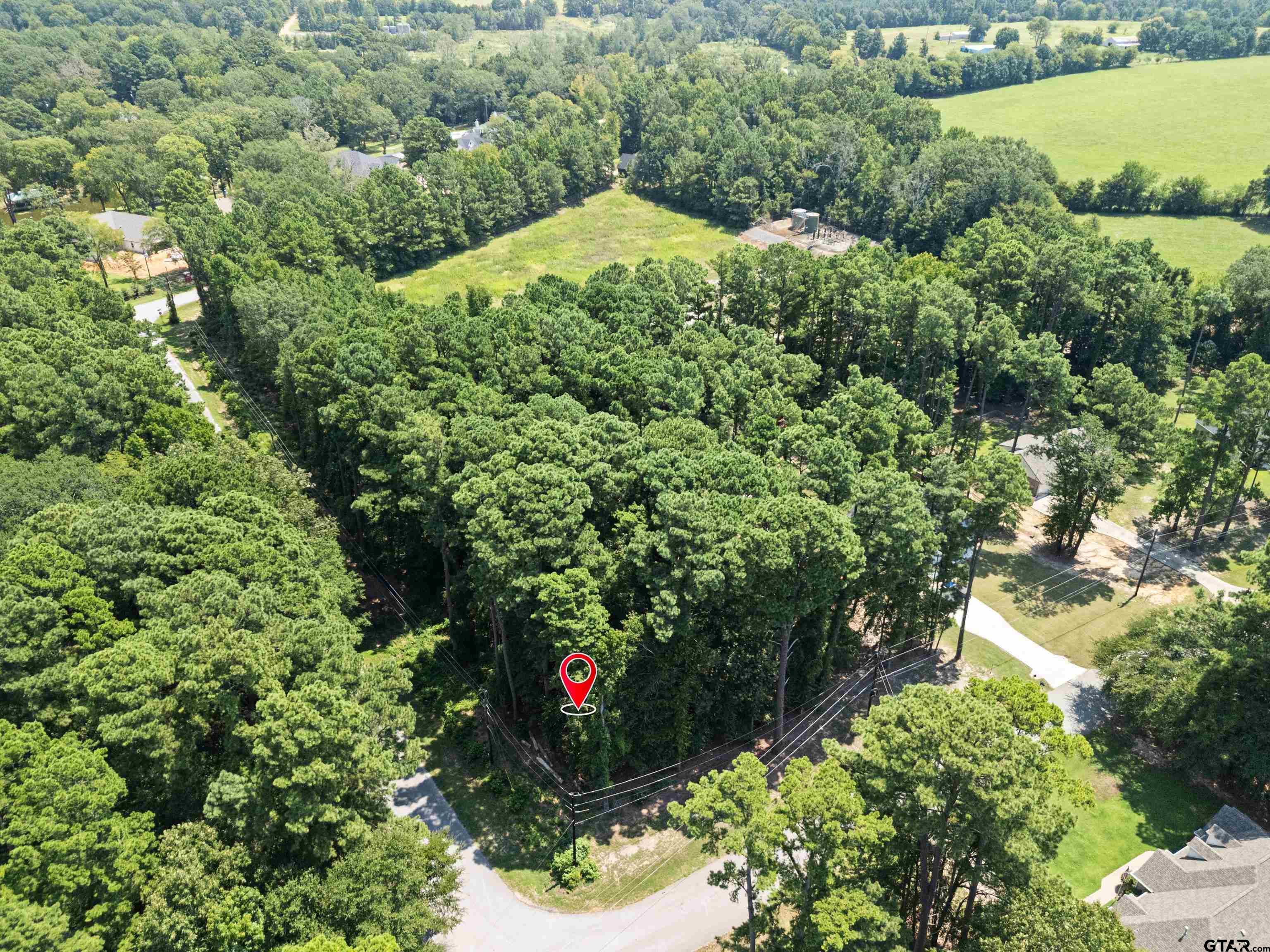 Image 1: Wooded corner lot