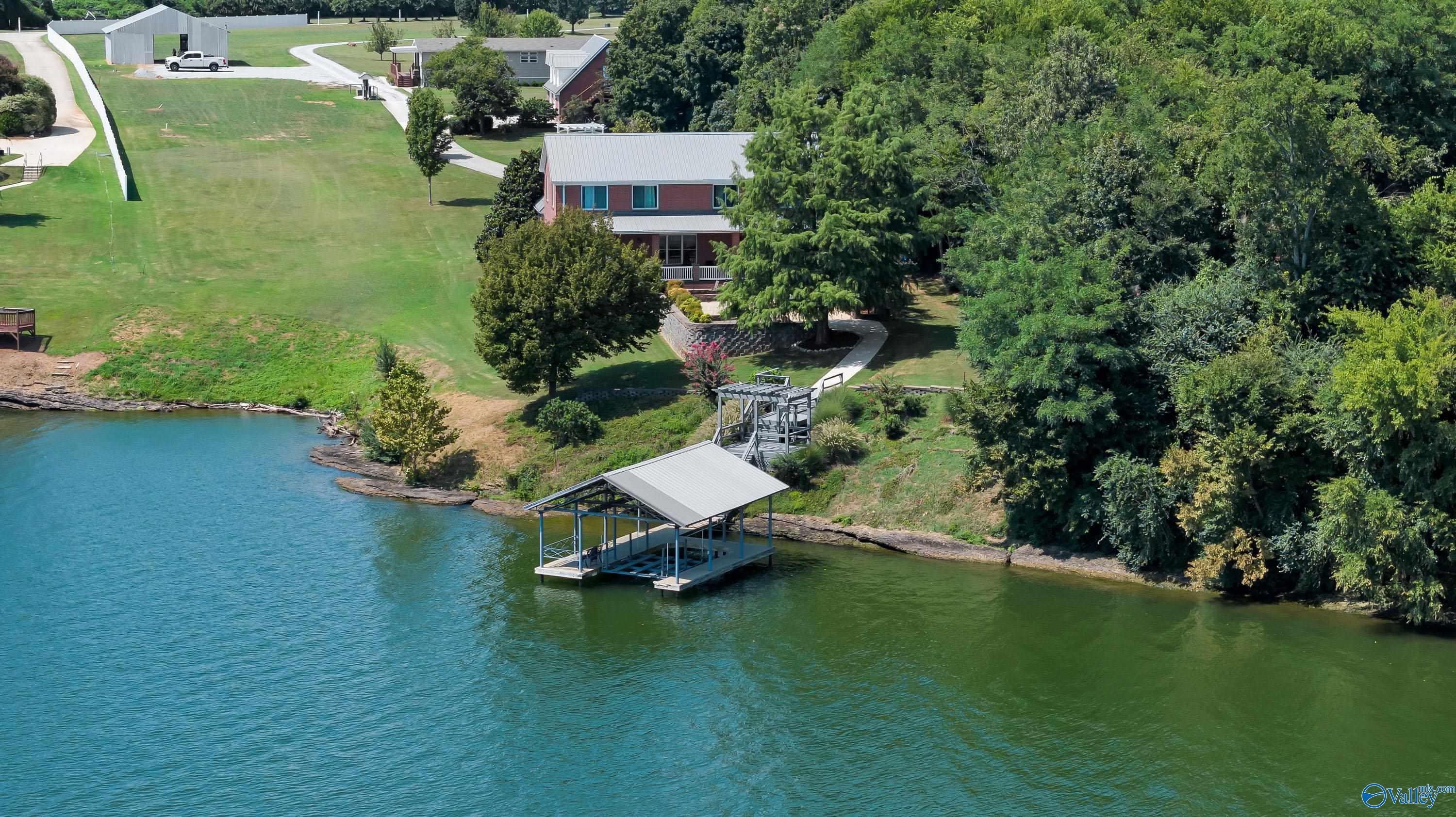 Image 2: Main home is tucked off the road approximately 700 feet- hidden oasis at the end of the driveway!