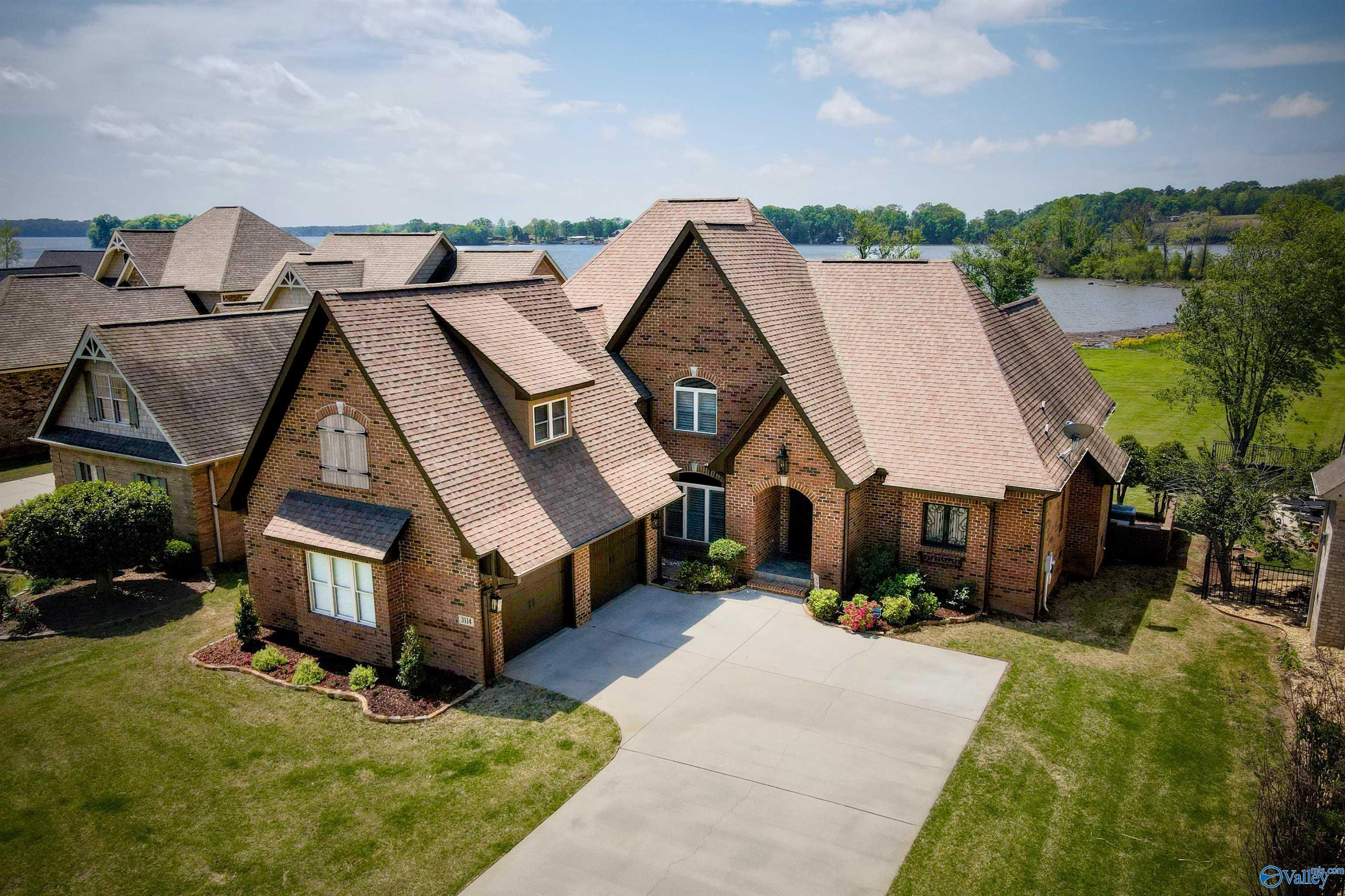Image 1: Welcome to 3114 Marina Drive, Athens AL, in the master-planned community, The Pointe.  With stunning water views from the home of Wheeler Reservoir, the community includes a marina for residents.  Nearly 4000 sq. ft of waterfront living space.