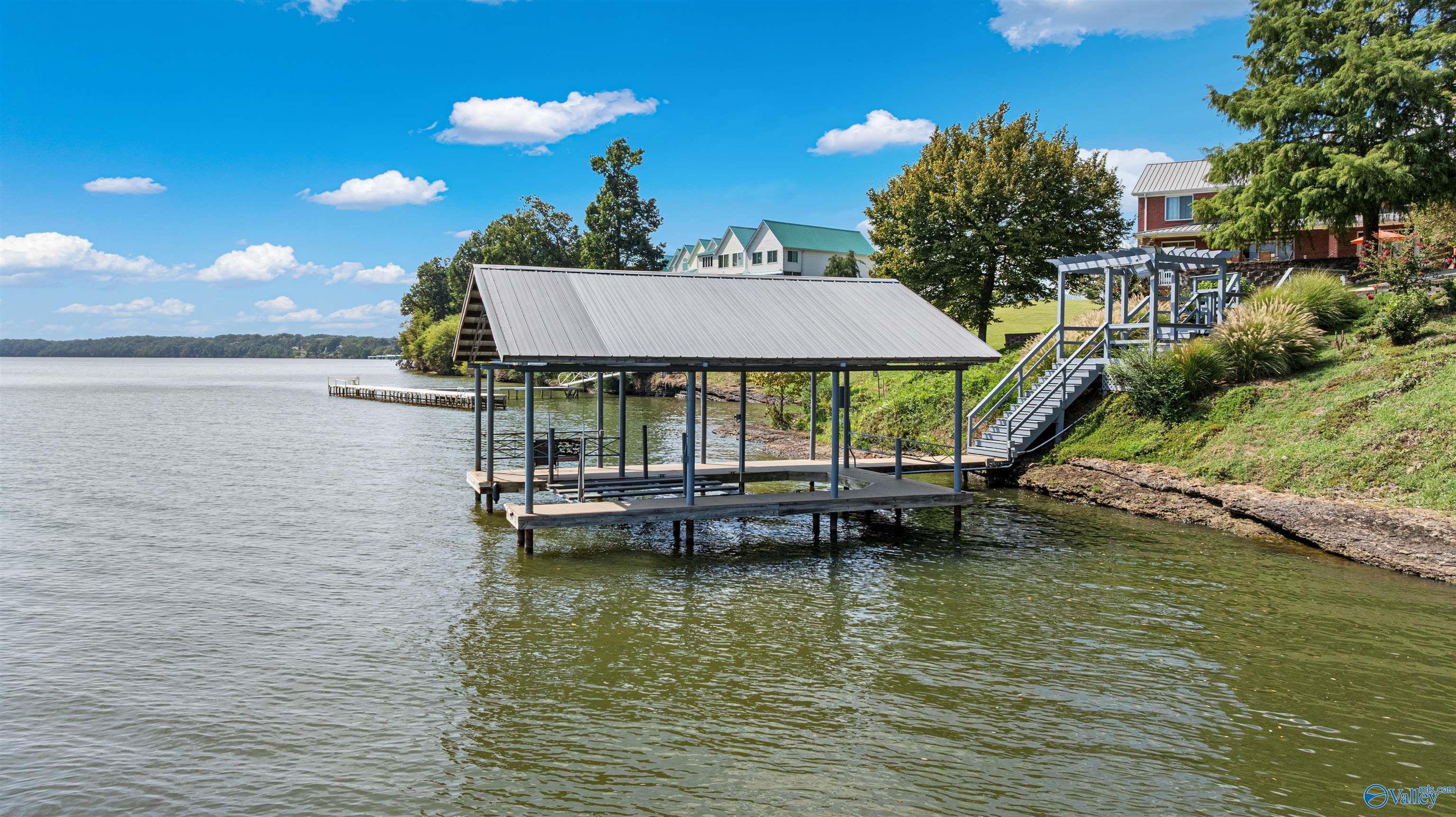 Image 1: Are you a fisherman who loves winter fishing? Great news!! It's year round water off the dock with a boat lift- you can jump in the boat and go all year long!!