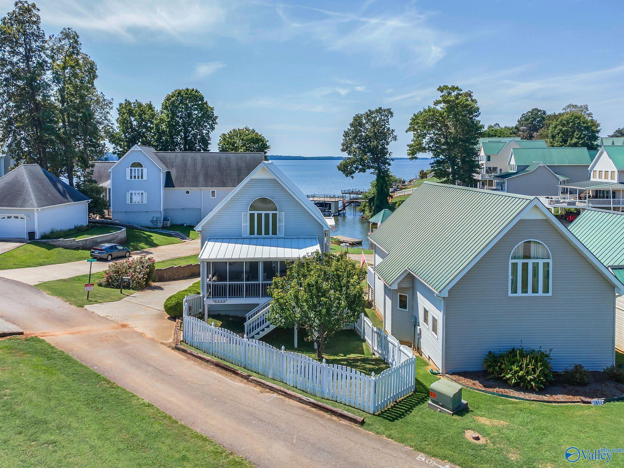 Image 1: Imagine pulling down your driveway and this first thing you see are your wonderful views of Wheeler Lake!