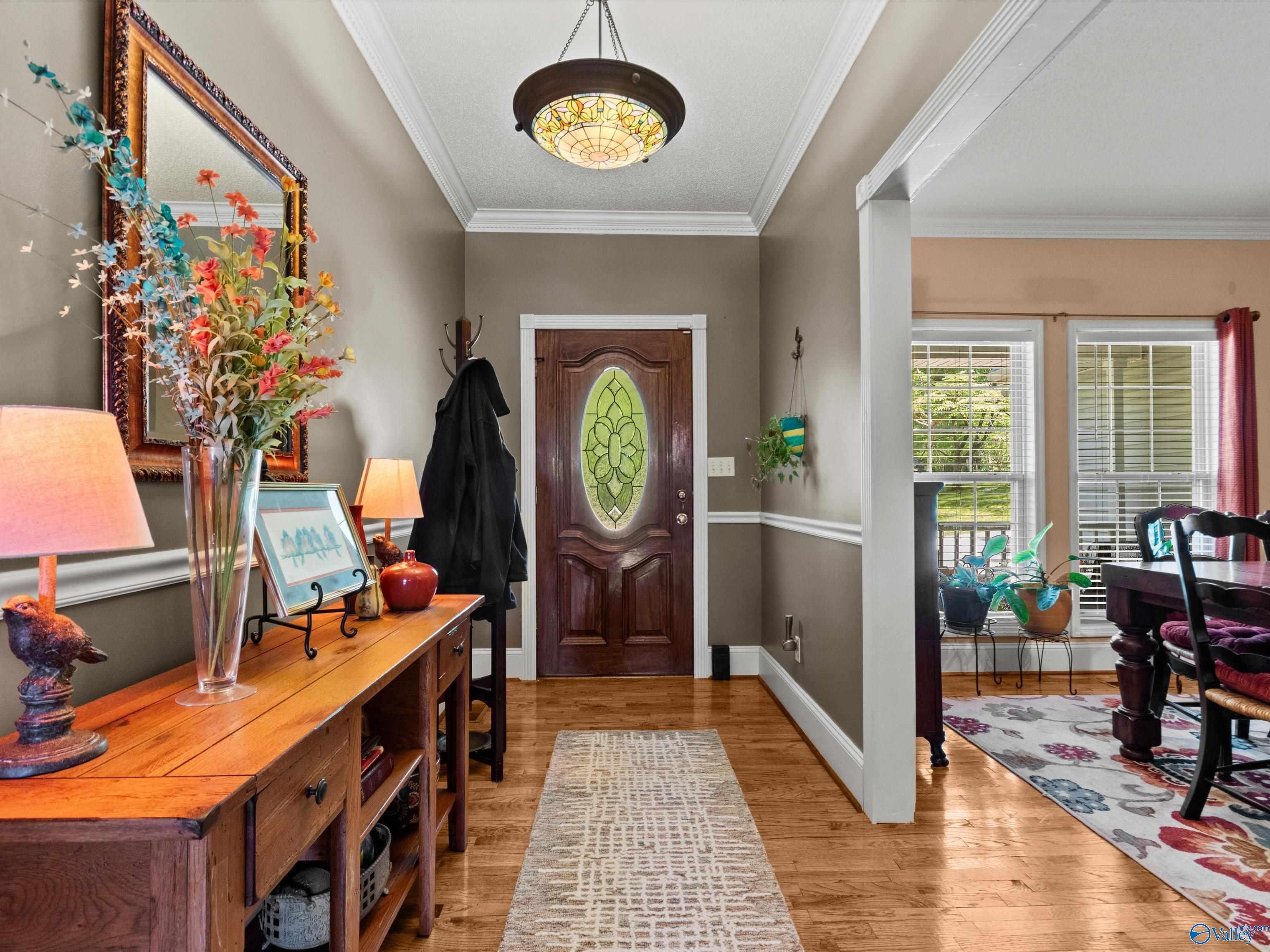 Image 3: Wood flooring, crown molding, chair rail