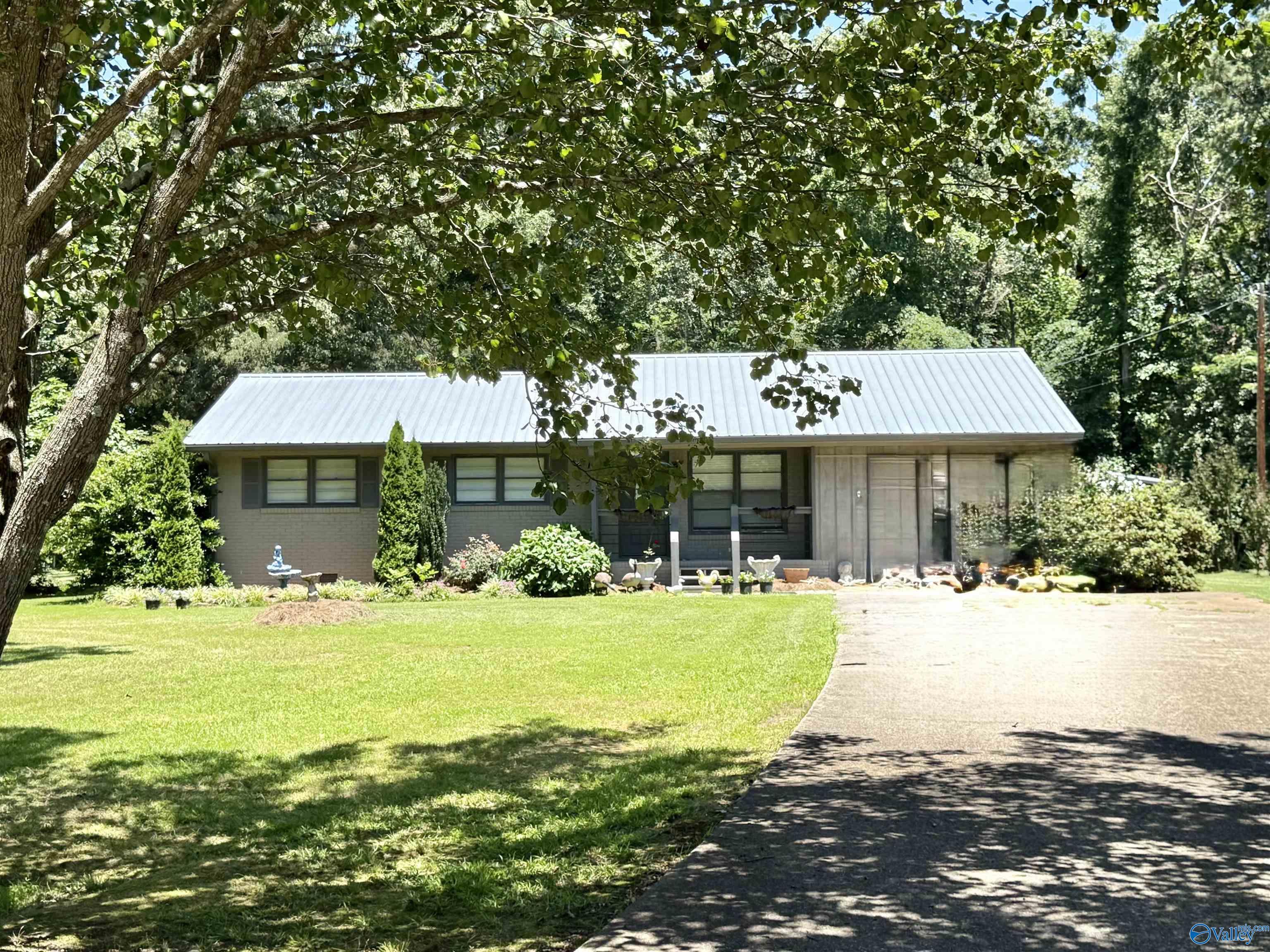 Image 1: View of home from street with exquisite landscape and large yard